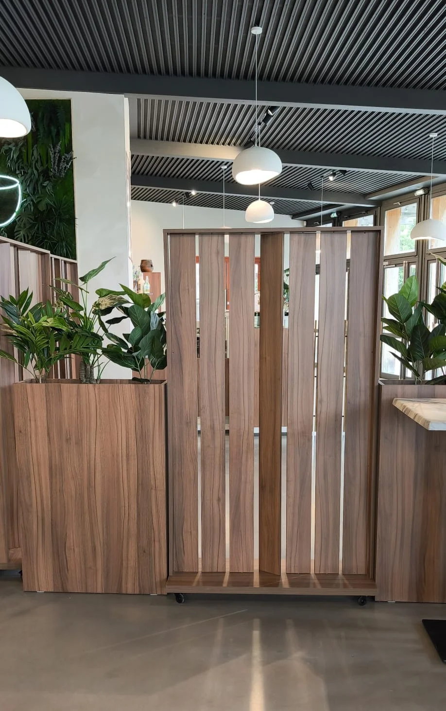 Jardinière et brise-vue à lames pivotantes dans un même décor bois